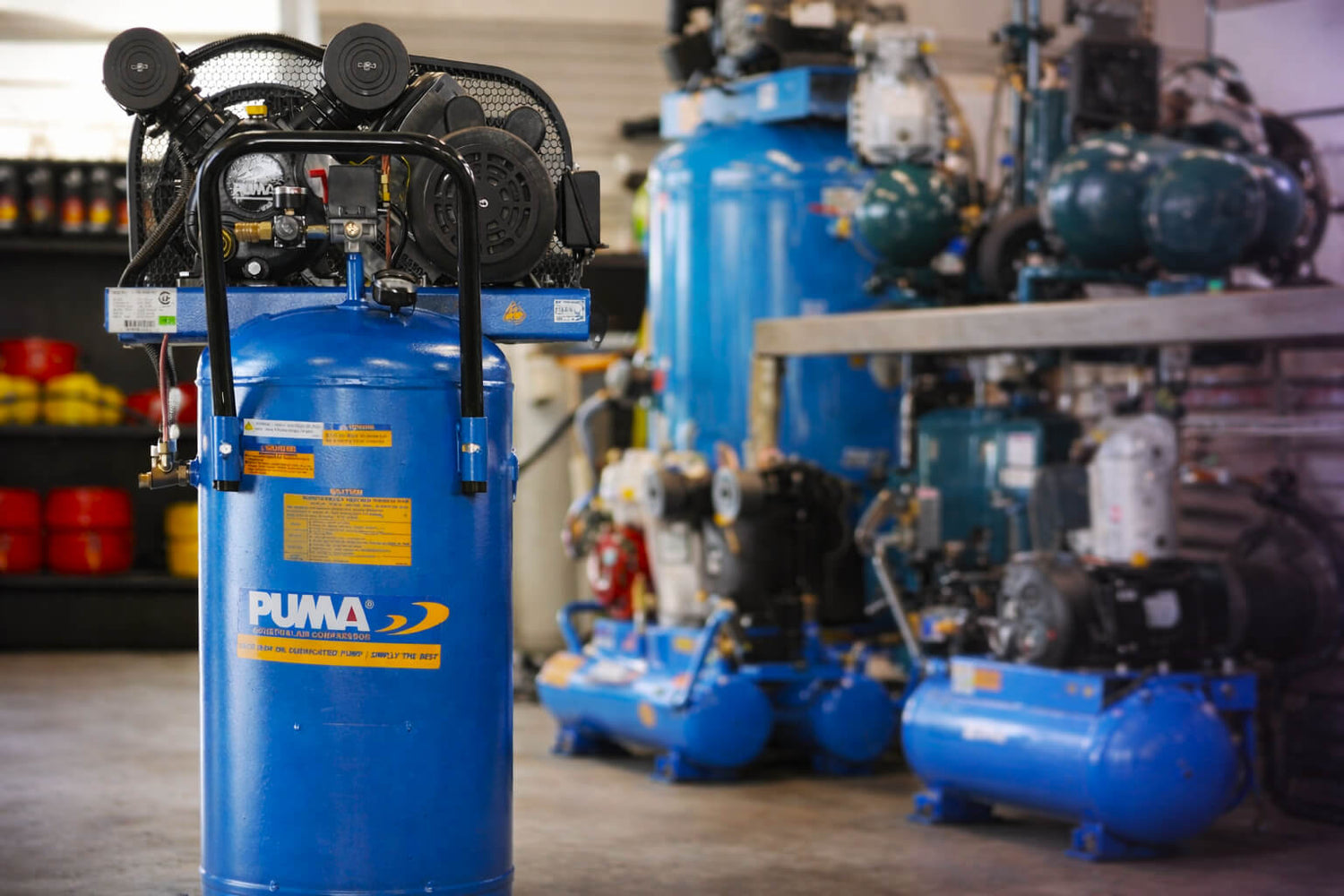 Blue Puma air compressor in a workshop setting with other equipment.